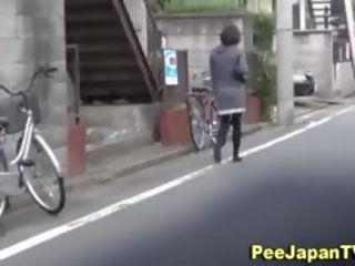Asian Pisses Behind Car